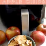 Air fryer in background with 4 apples on the table. Apple chips in a bowl.