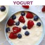 Bowl of yogurt topped with blueberries and raspberries