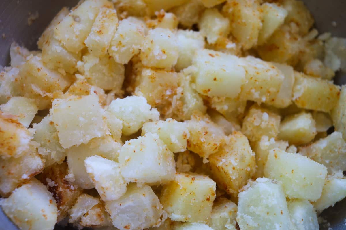 Closeup uncooked cut potato squares. 
