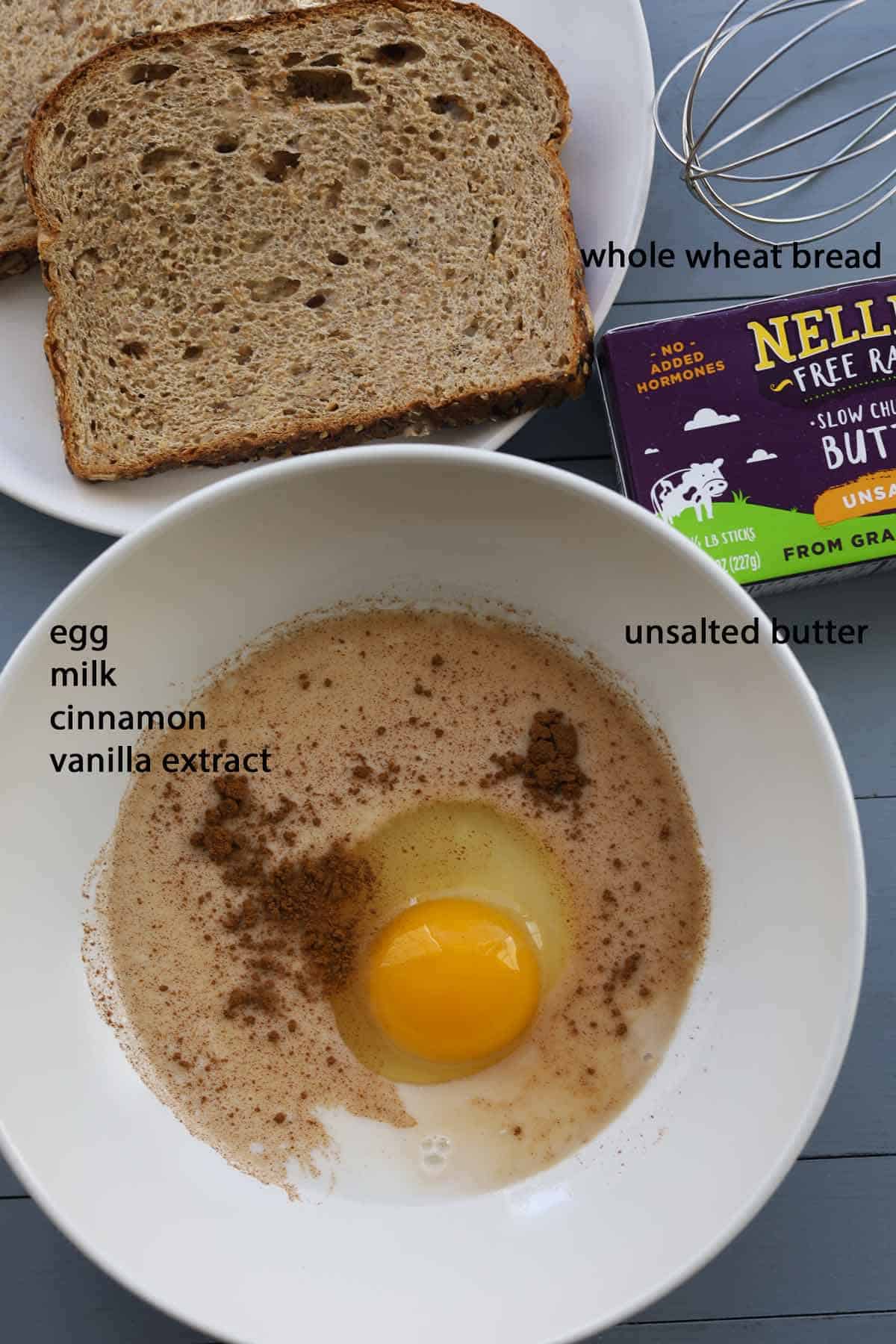 Ingredients: slice of bread, bowl with egg and seasoning, carton of butter and a whisk.