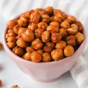 Close up image of roasted chickpeas with seasoning in a bowl.