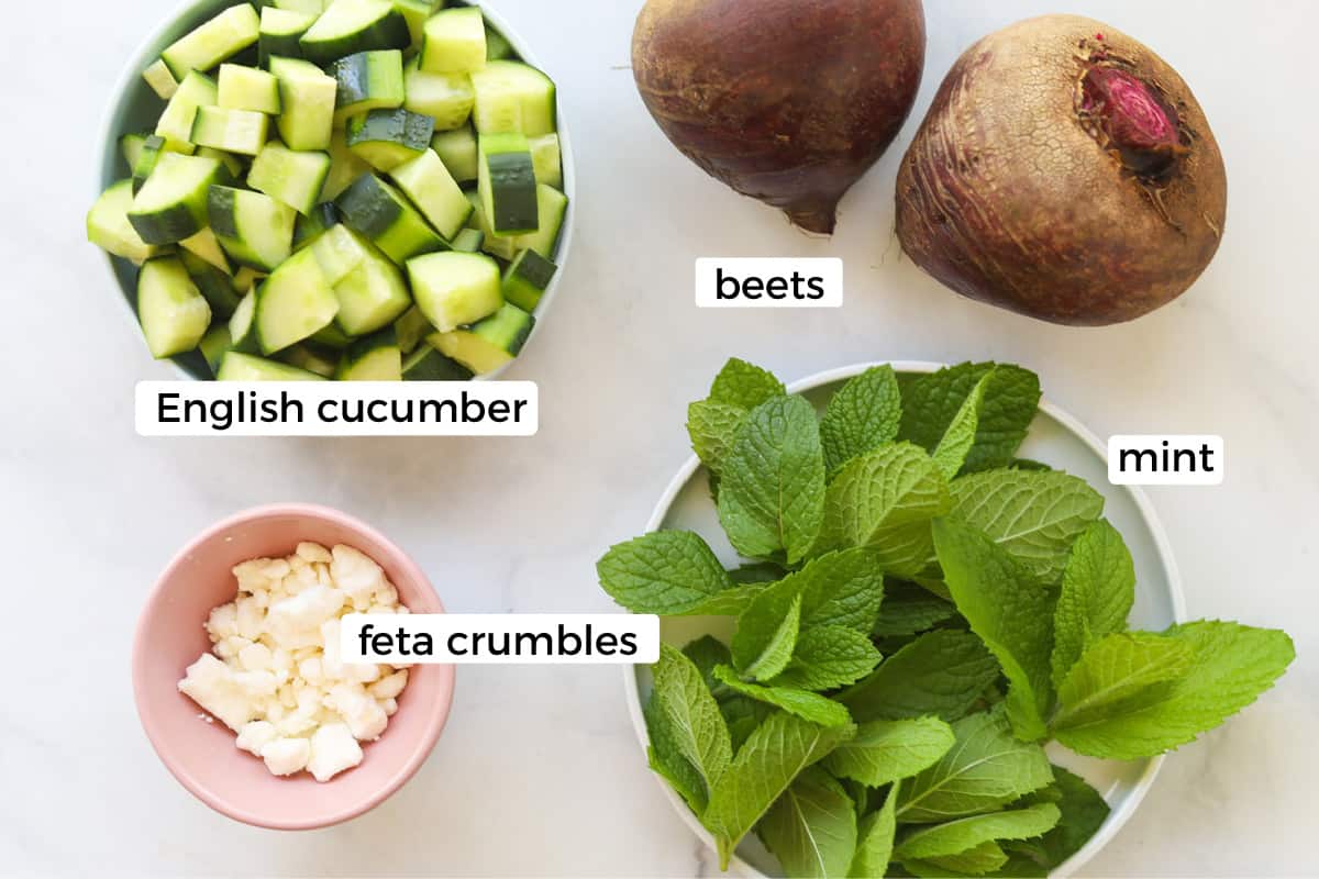 Ingredients for beet and cucumber salad on a table.