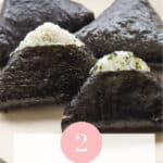 Plate of triangle shaped rice wrapped with seaweed.