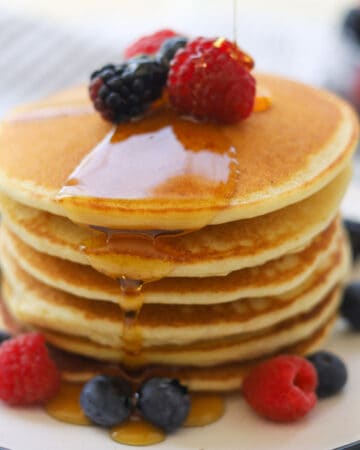 Stack of pancakes with syrup drizzle.