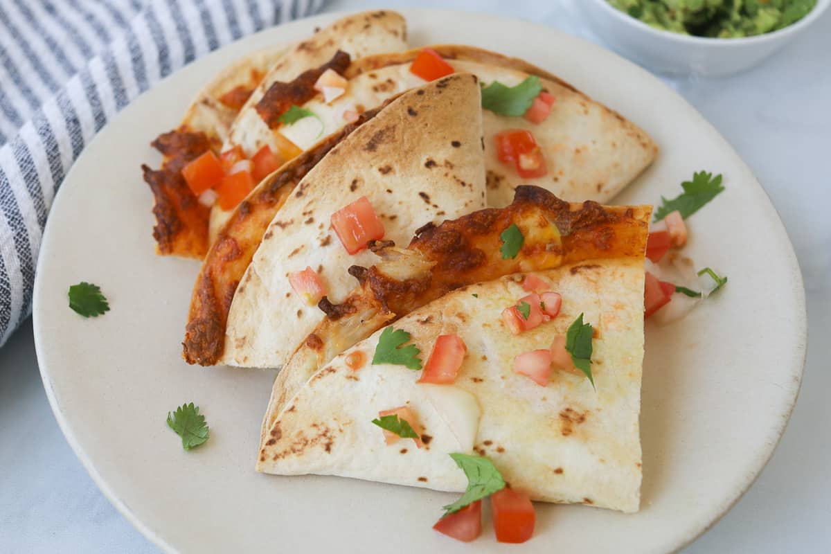 Cut up quesadillas on a plate.