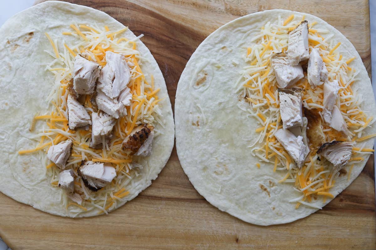 Two tortillas with cheese and chicken.
