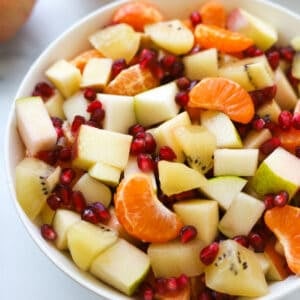 Cut up fruit mixed in a bowl.