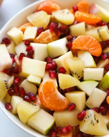 Cut up fruit mixed in a bowl.