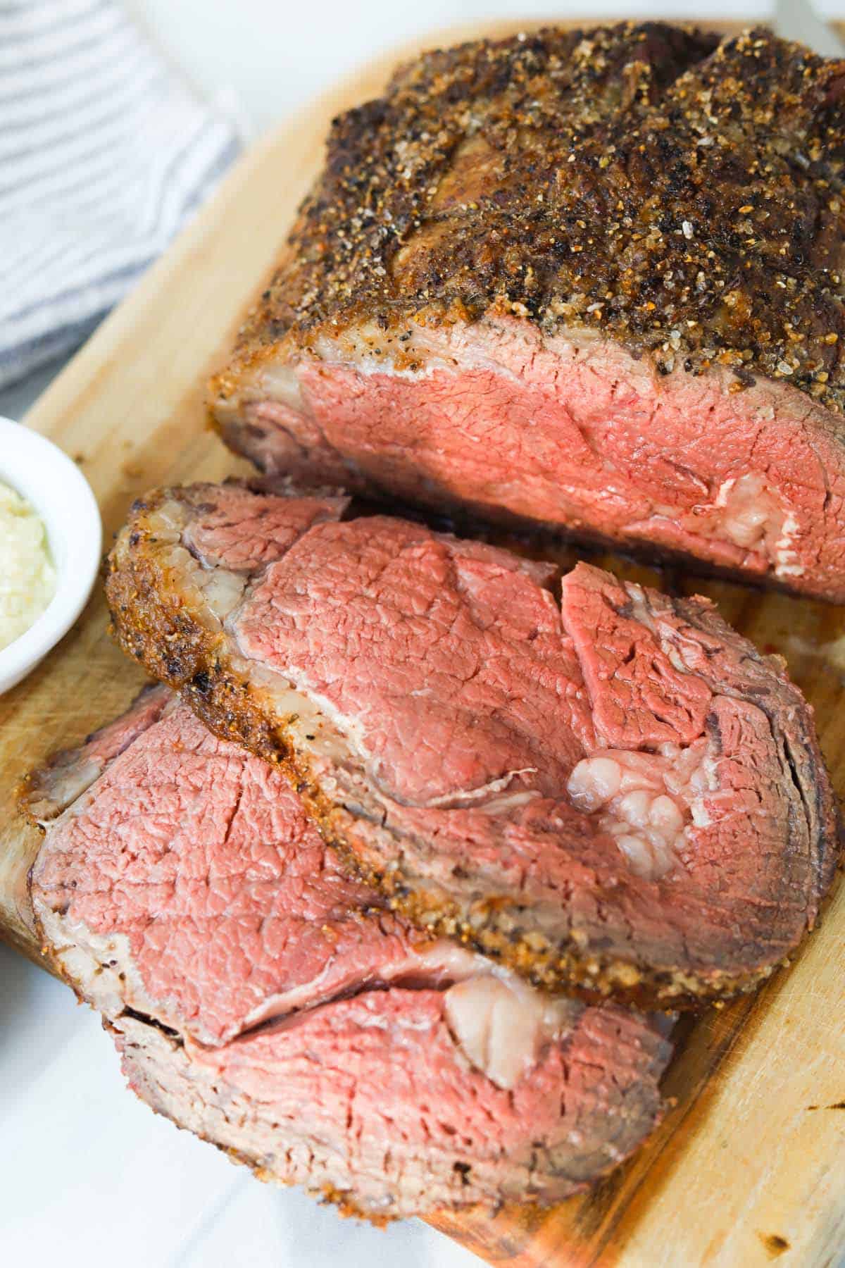 Cooked prime rib roast on cutting board.