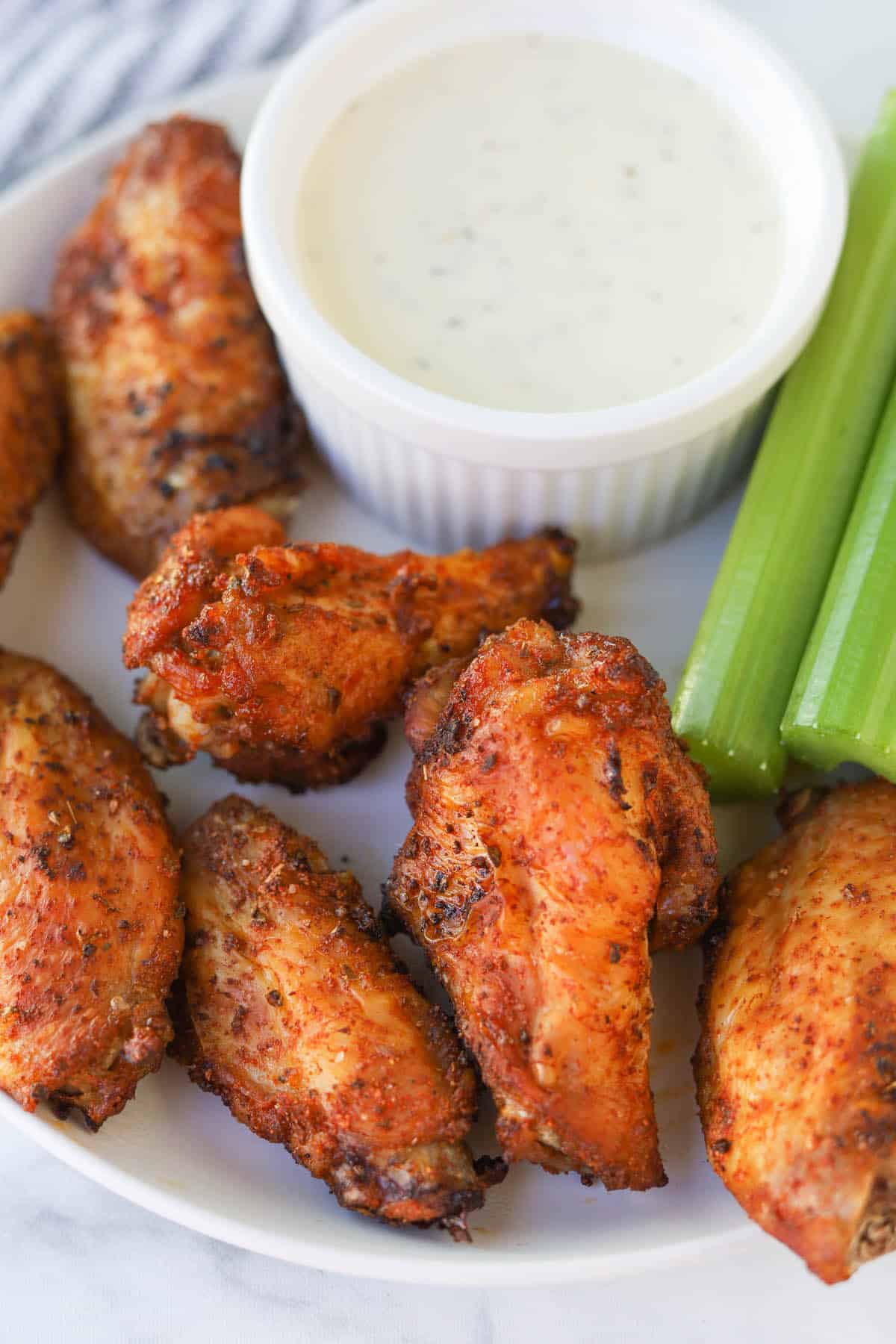 Plate of chicken wings with dip.