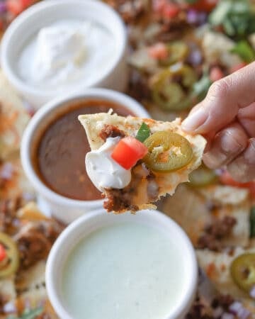 Close up image of nacho chip with toppings.