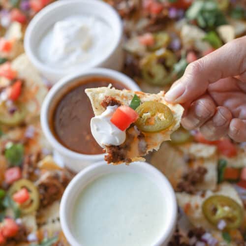 Close up image of nacho chip with toppings.