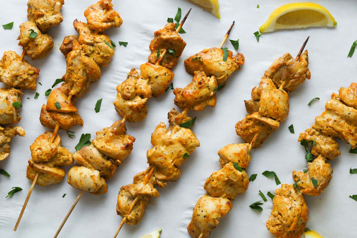 chicken skewers on a baking sheet