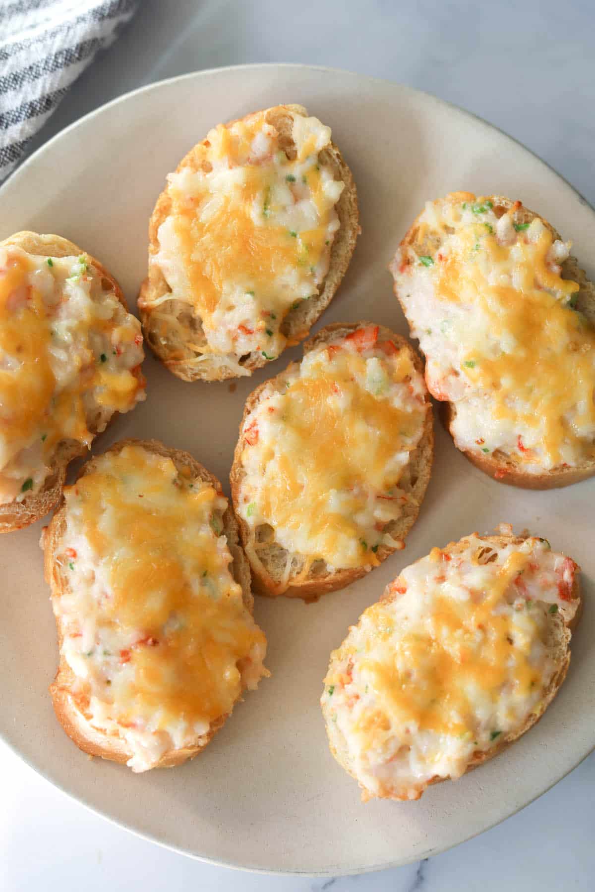 Shrimp topped with cheese on toast.