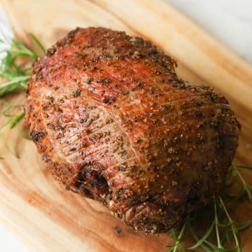Leg of lamb roast on cutting board.