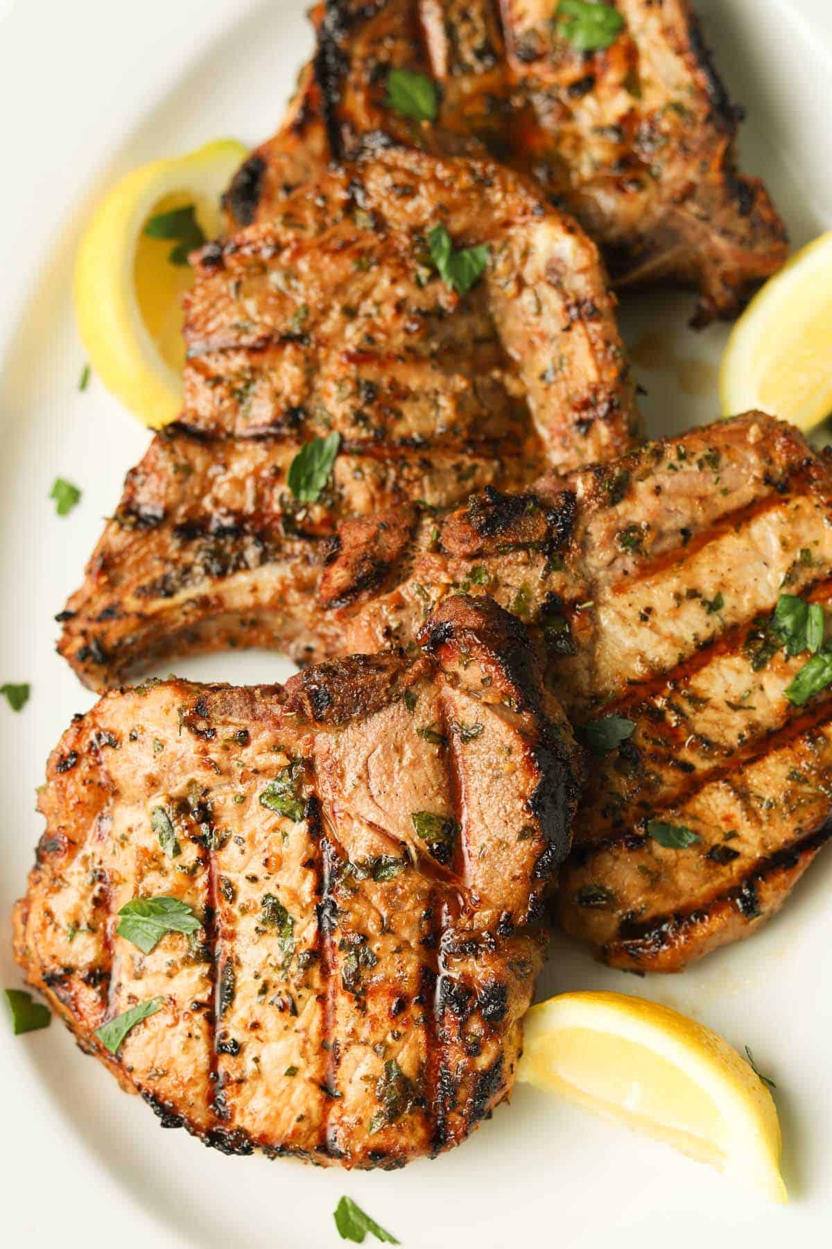 Plate of grilled pork chops with lemon.