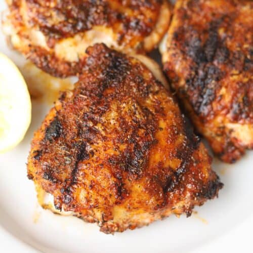 Grilled chicken thighs with skin.