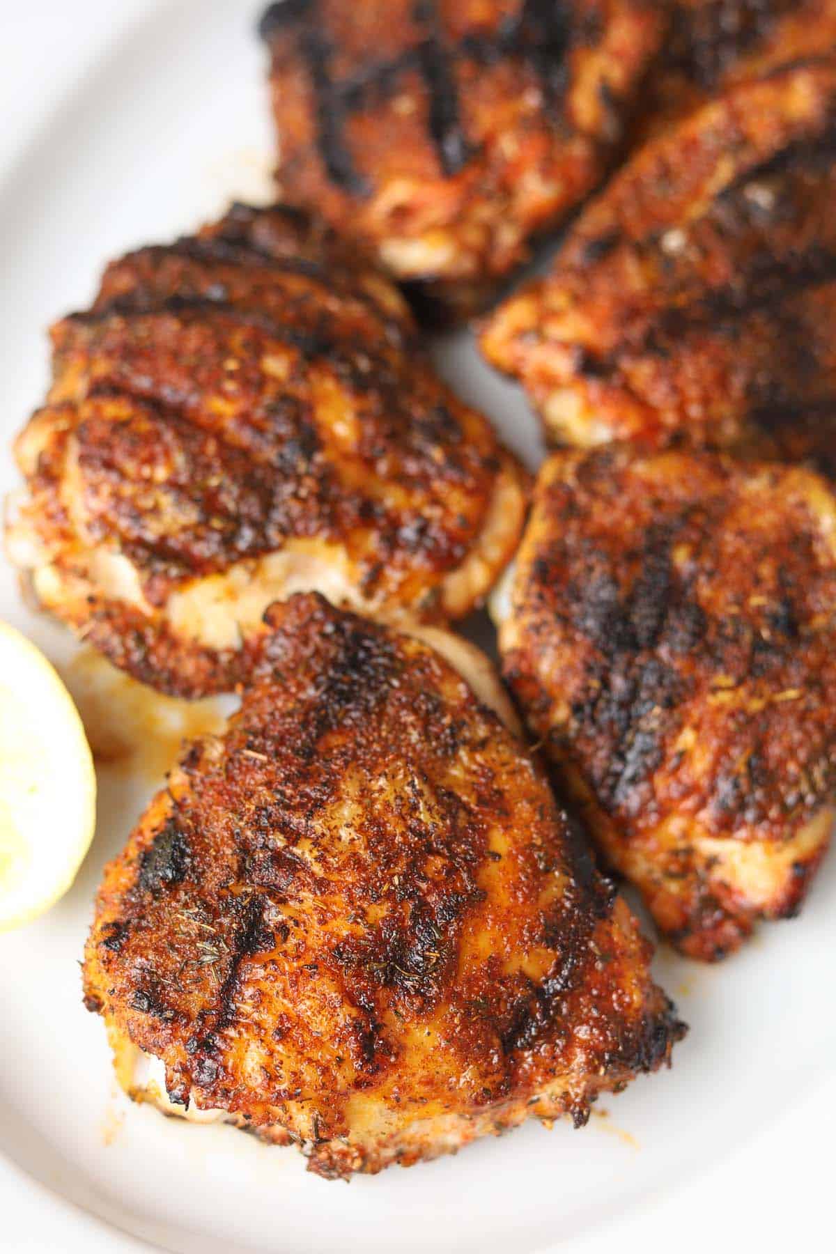 Grilled chicken thighs with skin.