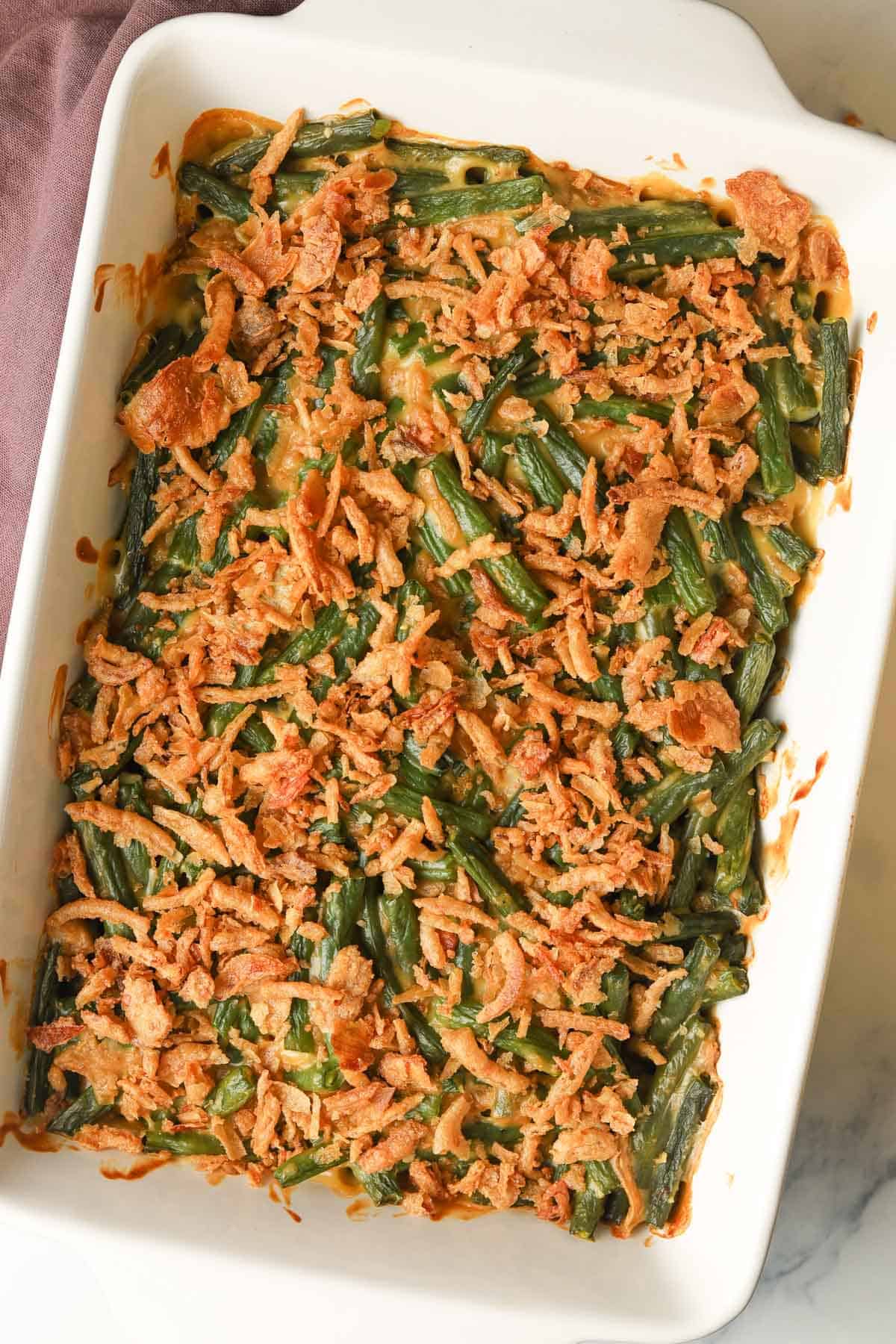 Green bean casserole with fried onions topping.