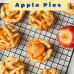 mini apple pies and apples on cooling rack.