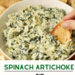 Bread dipping in fresh spinach dip.