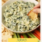 Bread dipping in spinach dip.