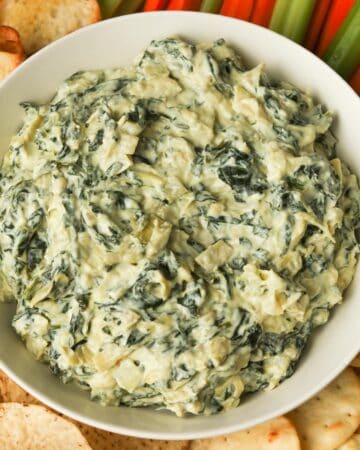 Spinach dip with chips and vegetables.