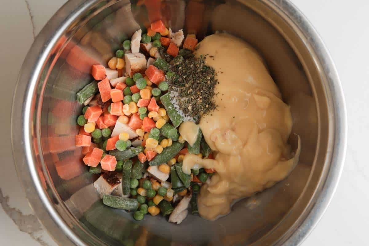 mixing ingredients for chicken pot pie.