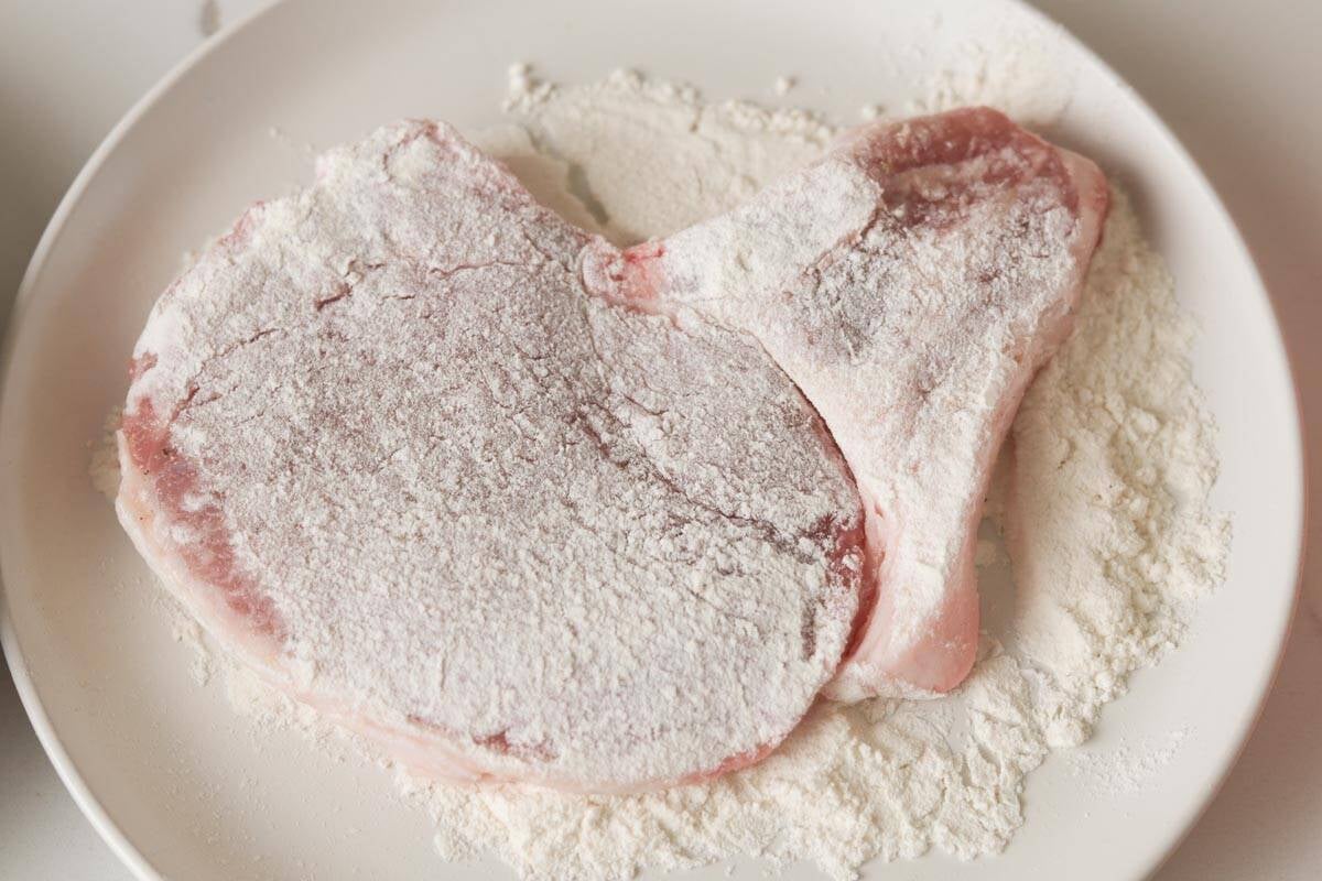 Bone in pork chops with flour coating.