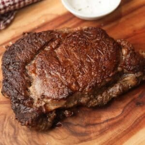 Seared Ribeye steak on a cutting board.