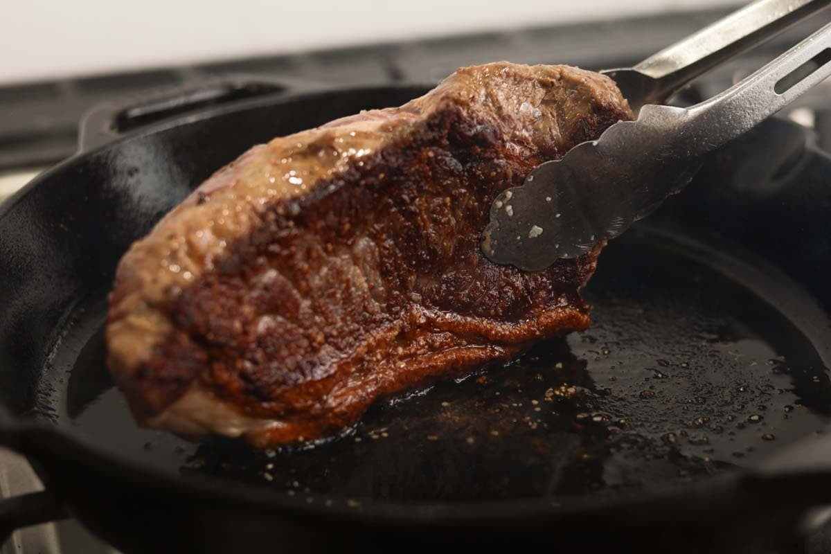 Searing steak on a cast iron.