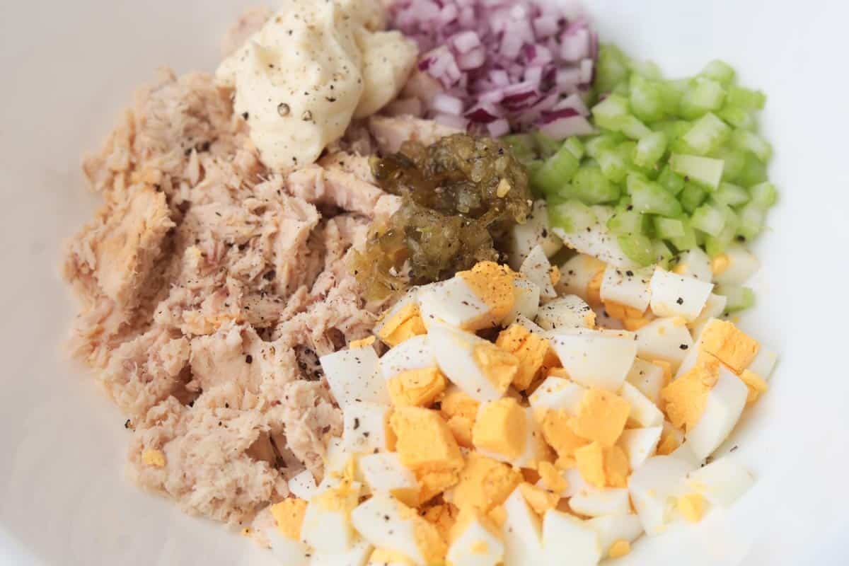 Tuna, egg, celery, mayo, onion, relish in bowl.