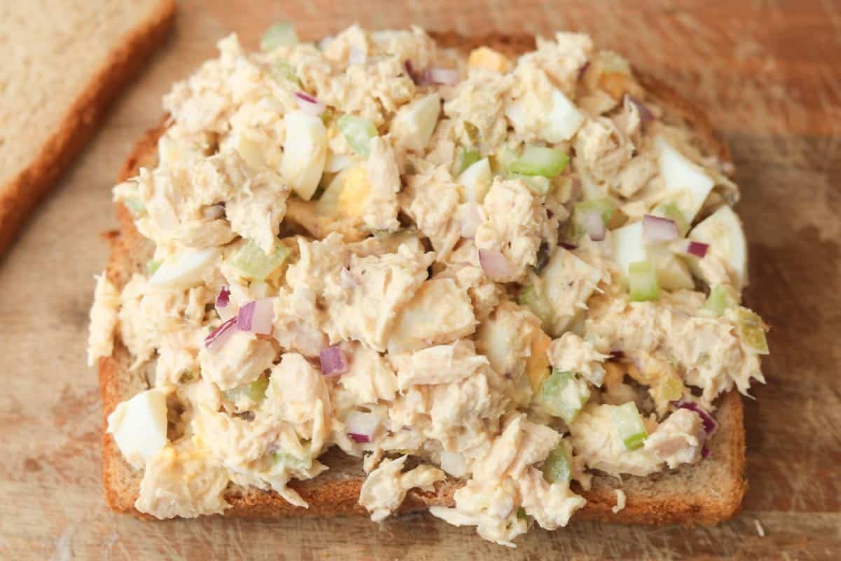 tuna egg salad on slice of wheat bread.