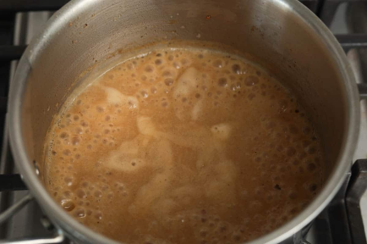 Gravy simmering in pan.