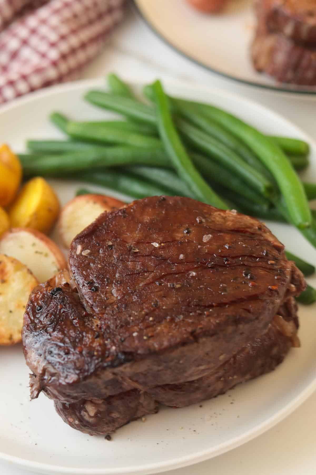 Seared filet mignon cut on a plate.