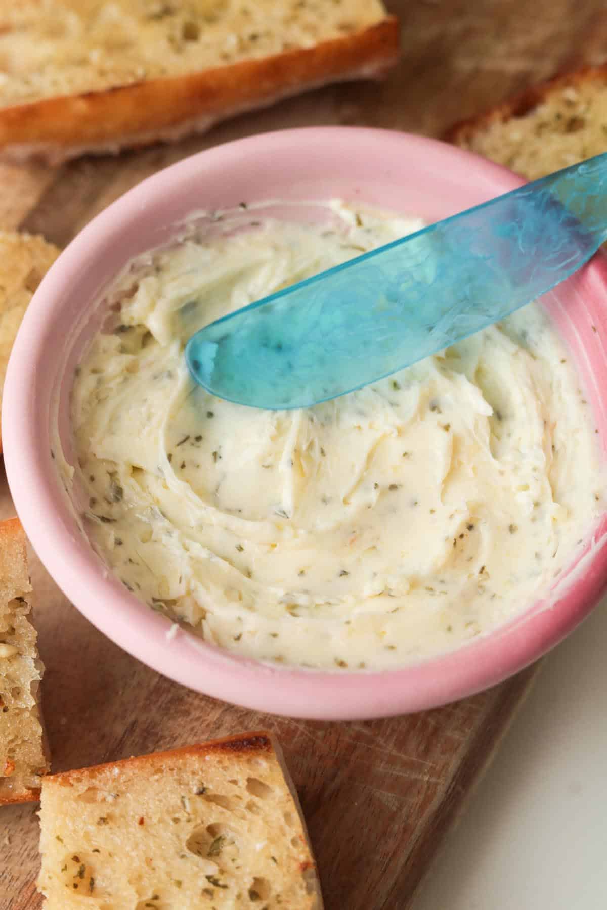 Butter spread in bowl. Garlic butter bread.