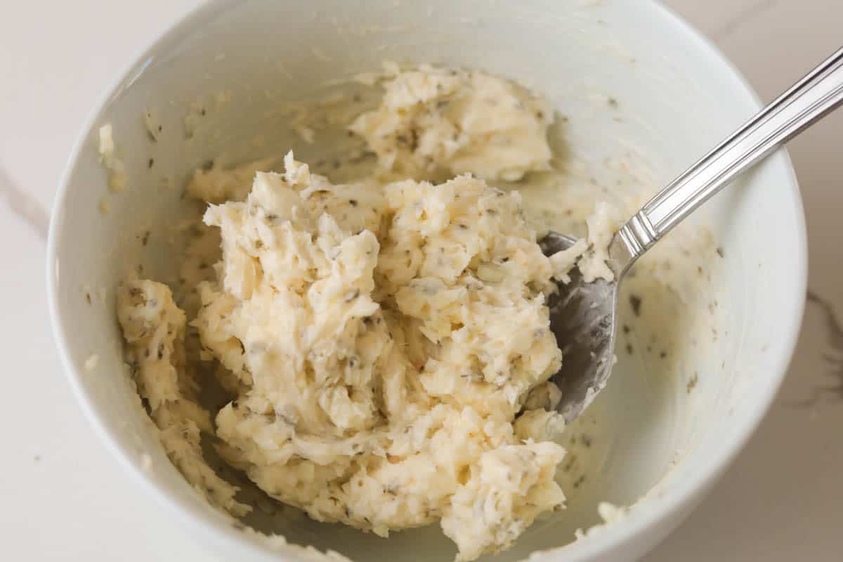 Mixing garlic butter in a bowl.