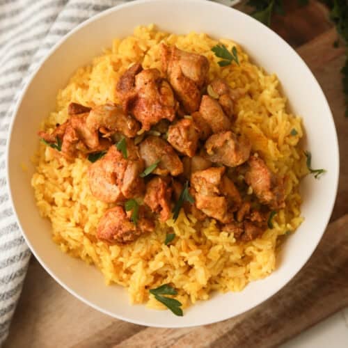 rice cooker chicken and yellow rice in a bowl.