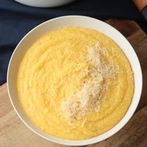 Polenta topped with grated cheese.