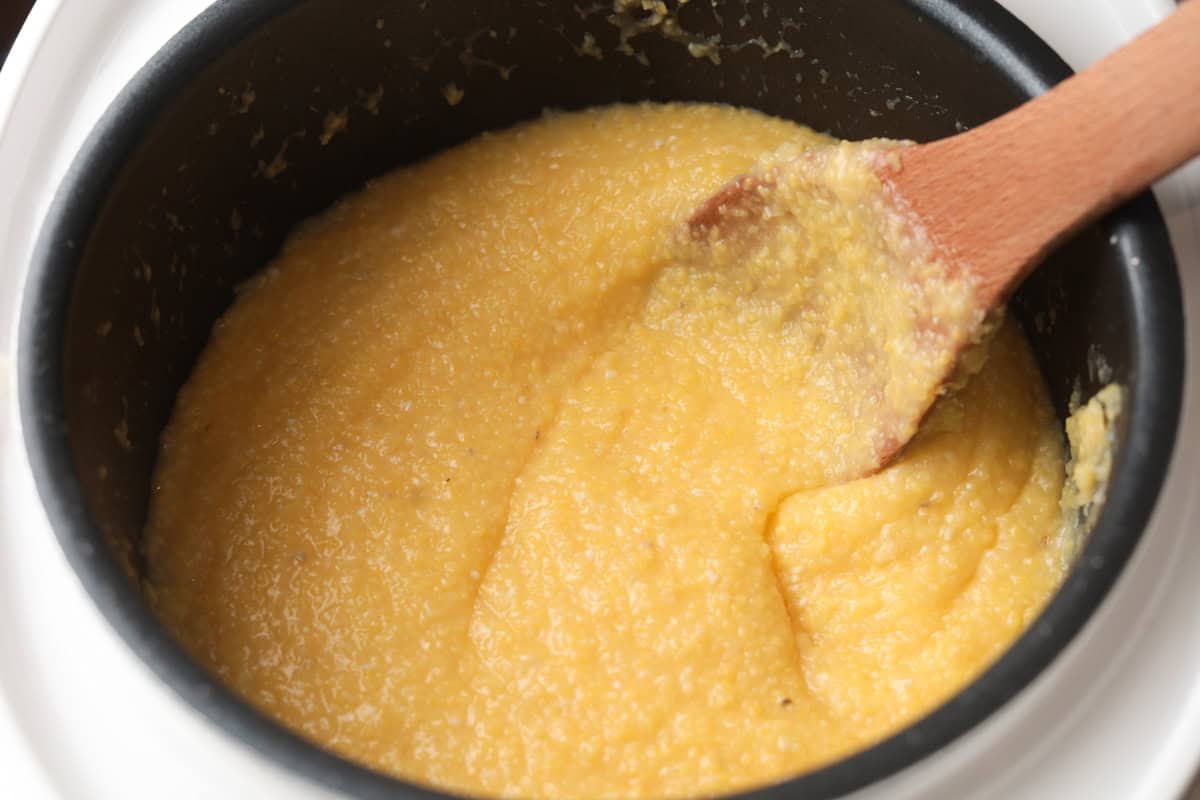 Stirring rice cooker polenta.