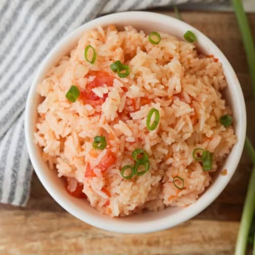 rice mixed with tomato in bowl.