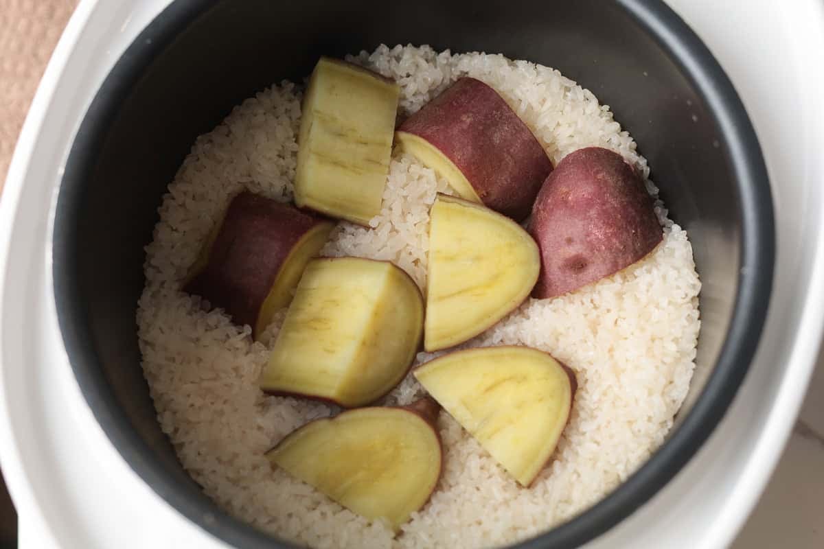 Rice and cut sweet potatoes in rice cooker.