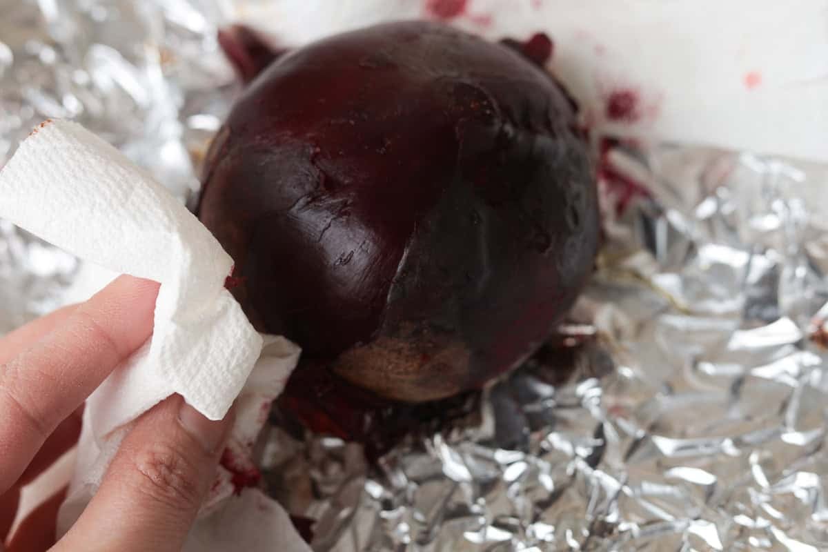 Peeling skin off whole beet