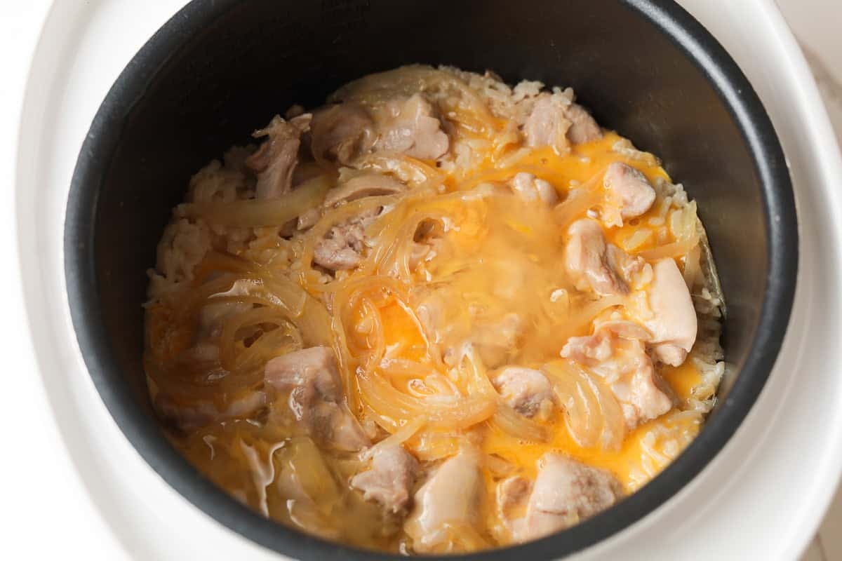 Rice cooker chicken oyakodon in pot.