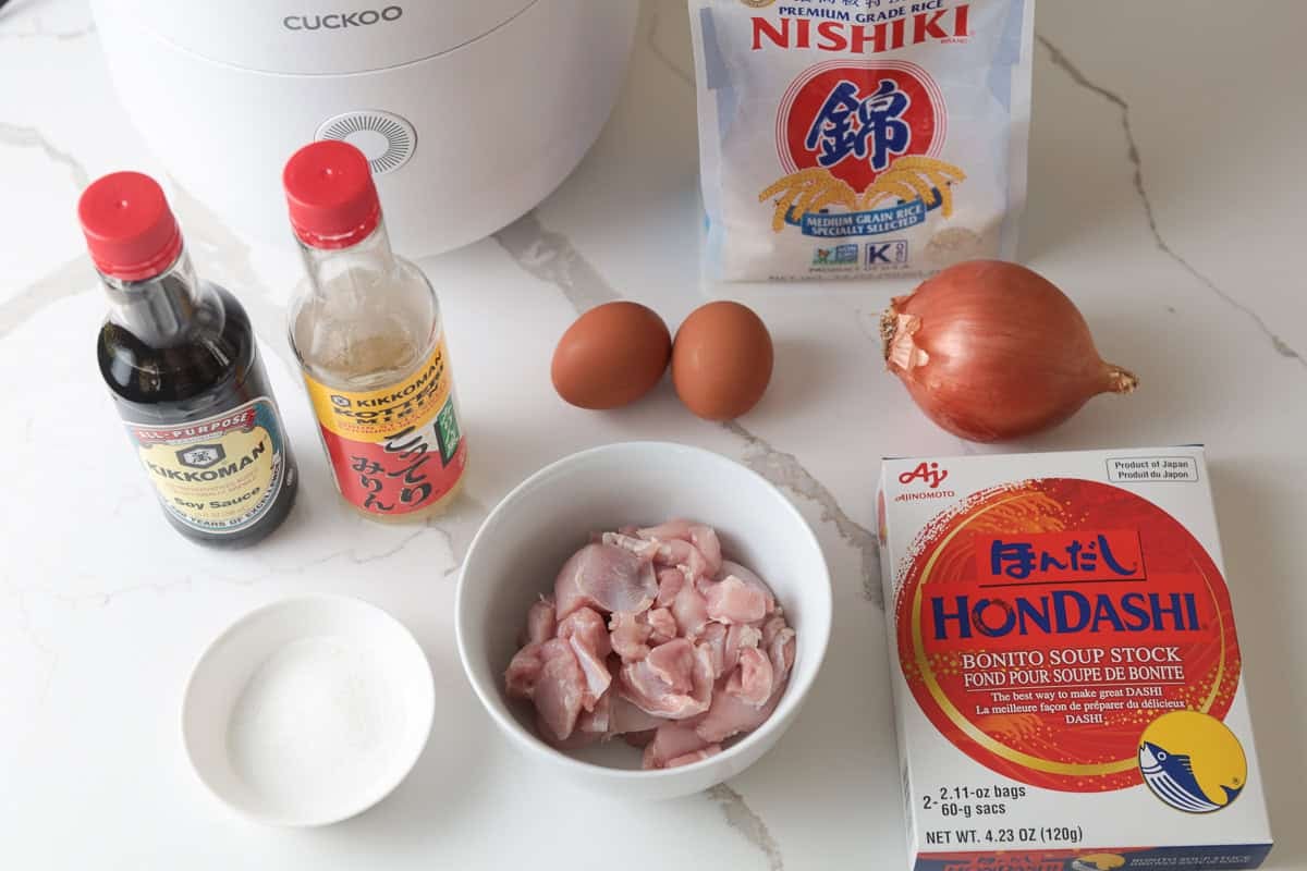 Rice cooker, soy sauce, mirin, chicken, hondashi powder, sugar, rice, eggs, onion.