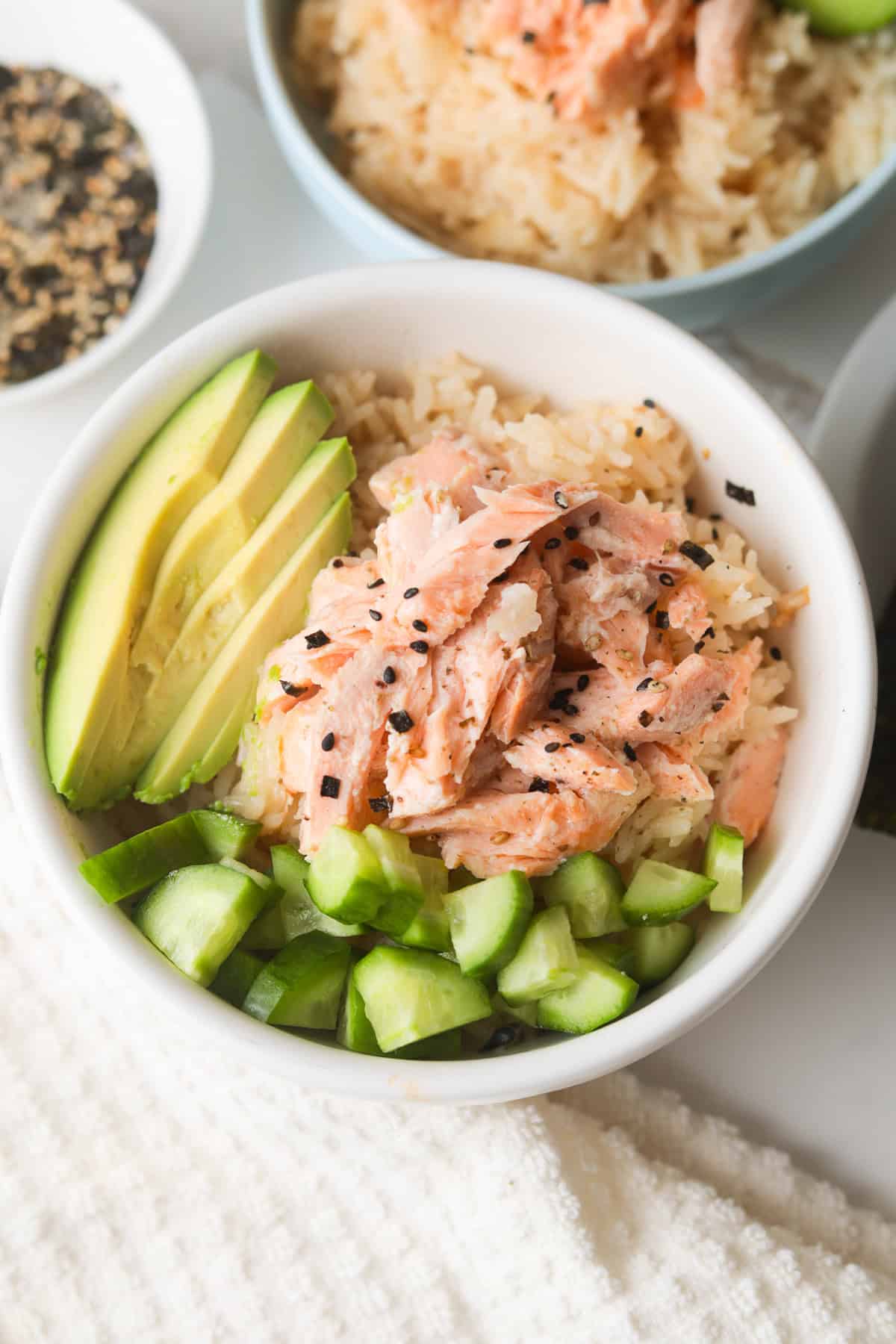 Rice bowl with salmon, cucumbers and avocado