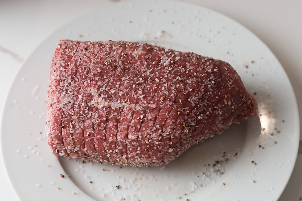 Seasoned uncooked eye of round roast.