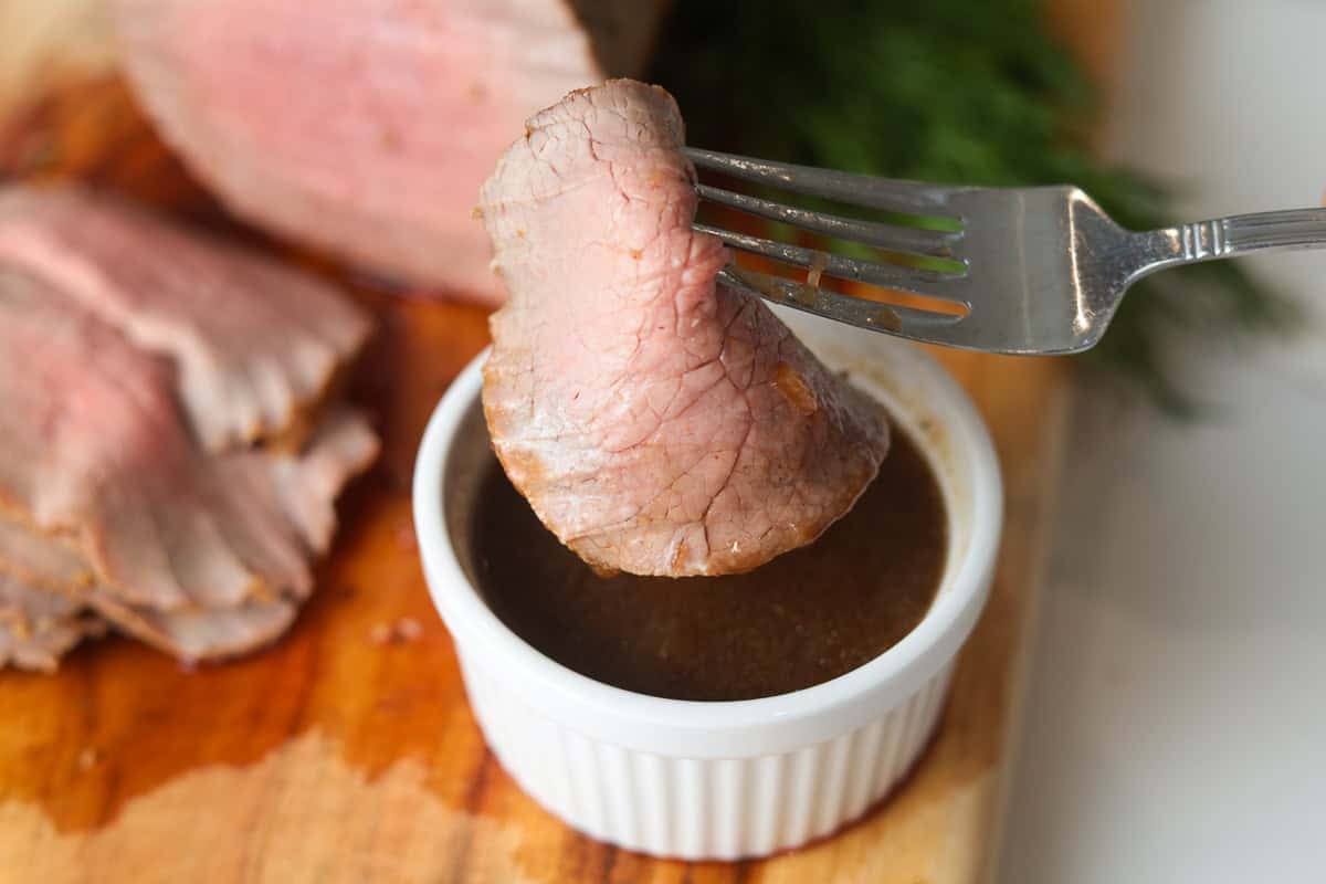 Sliced eye of round meat dipped in au jus