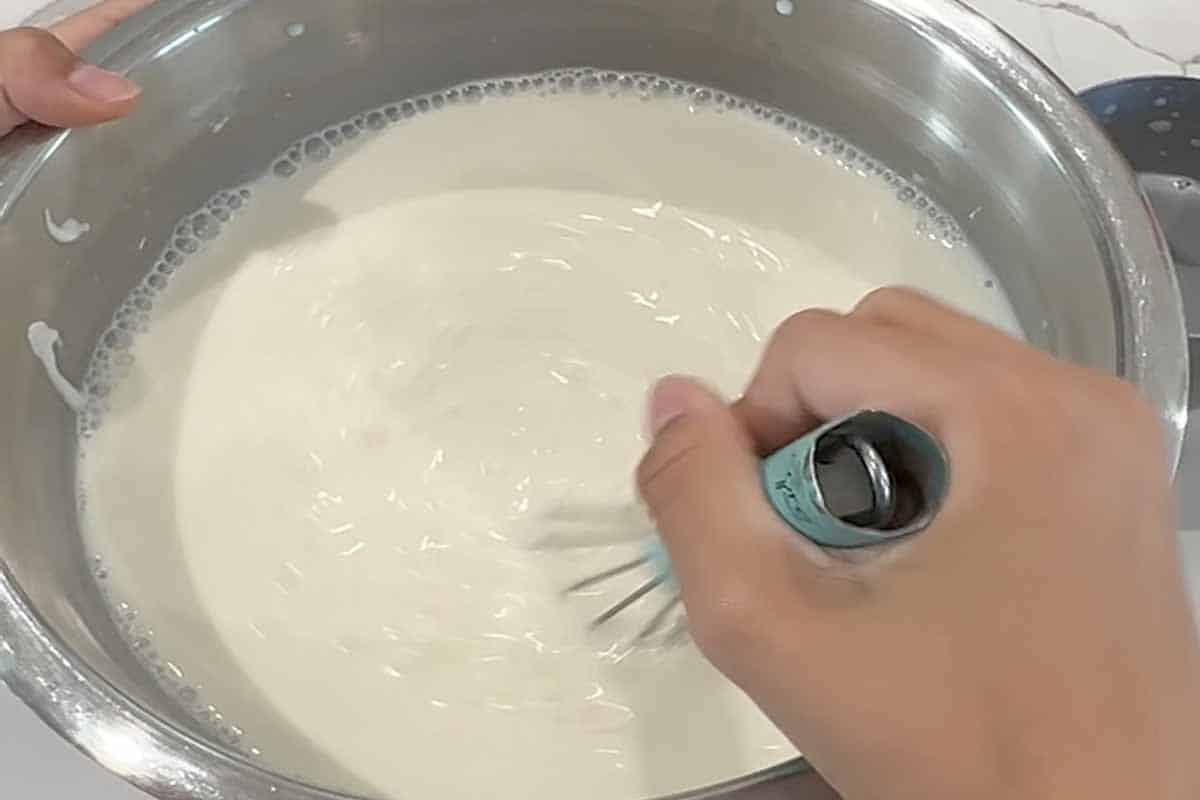 Mixing milk in a bowl.