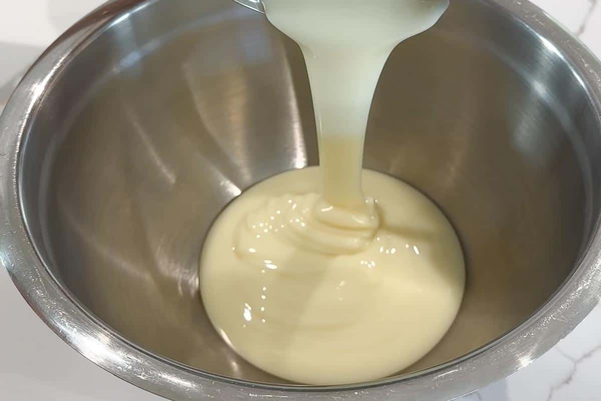 Pouring condensed milk in a bowl.